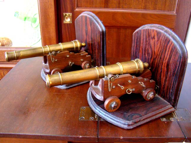 A pair of scale model 24 pounder Naval Cannons with bookend mounts